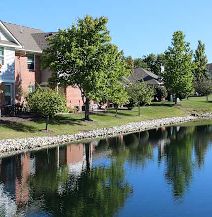 a body of water with houses next to it