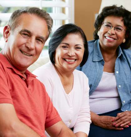 Four people sitting together and smiling.