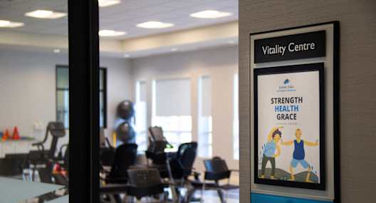 a picture of a health center with chairs and a poster on the wall