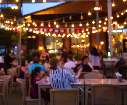 people eating at a restaurant with lights hanging from the ceilingat Homestead Talking Glass, Prescott Valley Arizona