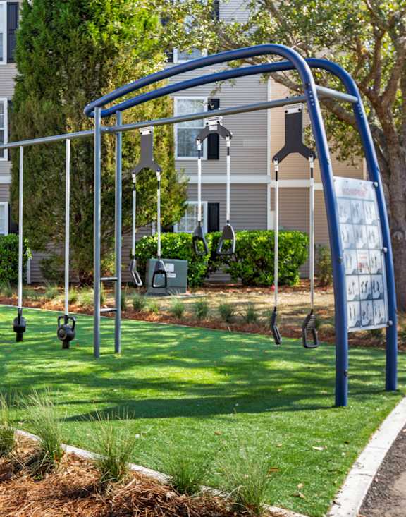 A playground with a swing set and a blue frame.