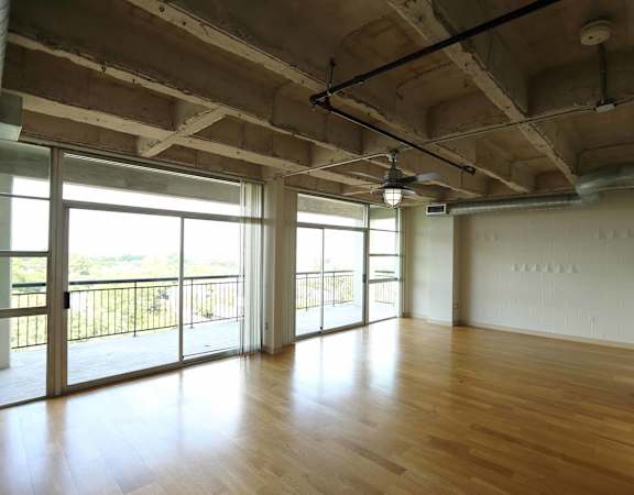 Wooden floors and large windows overlooking private patio