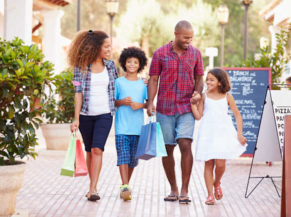 a family walking down the street with shopping bags at Oakridge Apartments, Antioch, CA, 94509