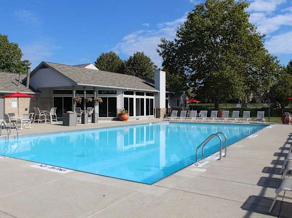 a swimming pool with a building in the background
