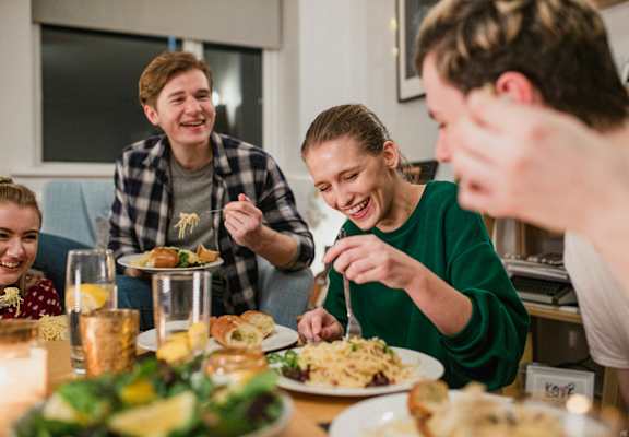 A group of people are enjoying a meal together at a table.
