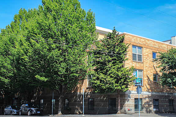 A modern building with a parking lot in front of it.