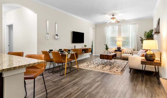 A modern living room with a dining table and chairs.