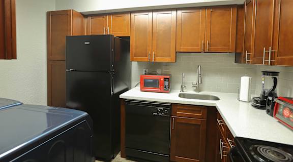 kitchen with white counters and black appliances