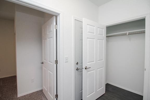 A white door is open to a hallway.