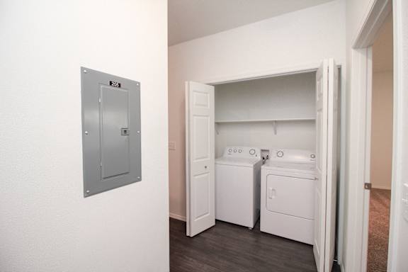 A small laundry room with a washer and dryer.