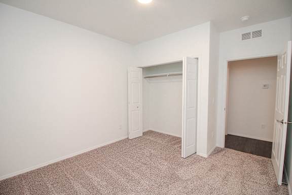 A room with a carpeted floor and white walls.