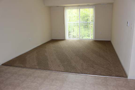 an empty living room with a sliding glass door