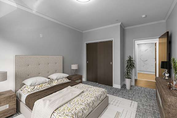 a bedroom with a bed and a door to a bathroom