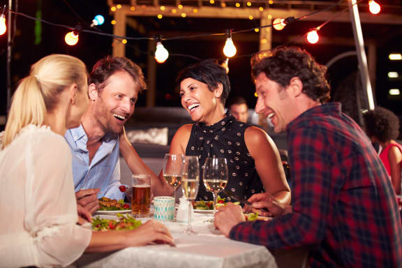 a group of people eating and drinking at a table
