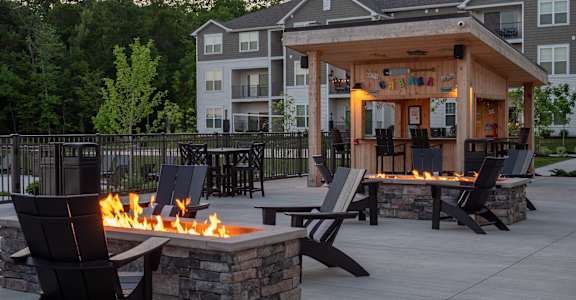 an outdoor entertaining area with a fire pit and patio furniture at The Bend, Lancaster, OH