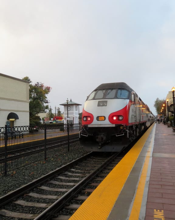 a train pulling into a train station on the tracks