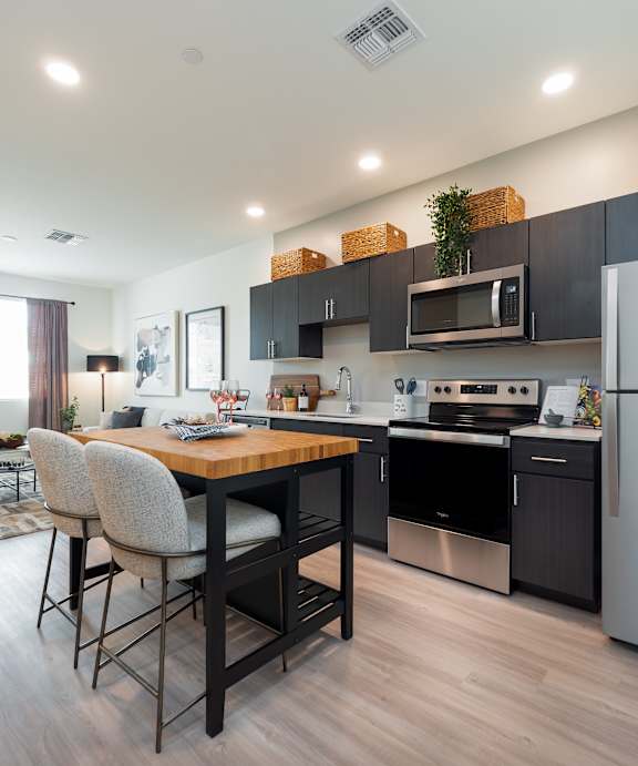A modern kitchen with a dining table and chairs.