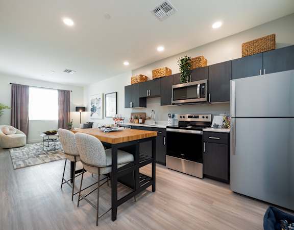 A modern kitchen with a dining table and chairs.at The 89 on Hayden, Scottsdale, 85257