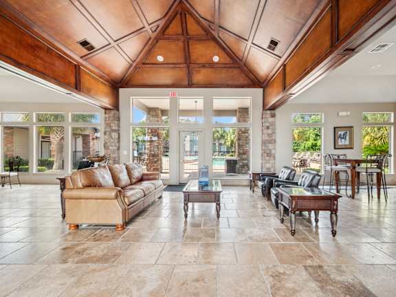 A living room with a tan couch and a coffee table.