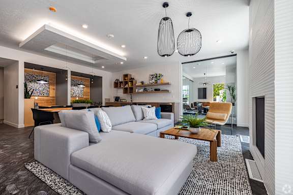 A modern living room with a grey sofa and a wooden coffee table.