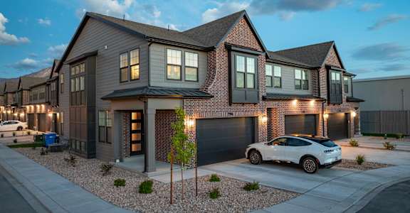 A modern house with a white car parked in front.