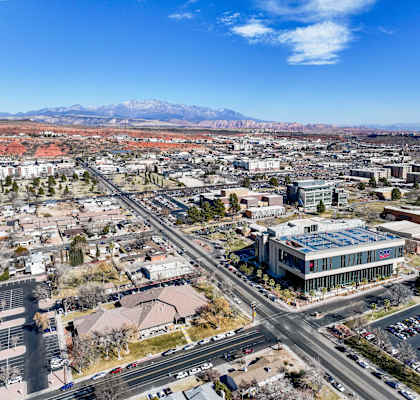 A cityscape with a mountain range in the background.