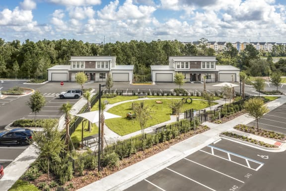 an aerial view of a parking lot with a park and buildings at The Haven at Lake Britt Apartments, Winter Garden, FL 34787