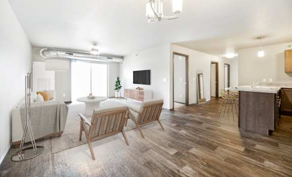 A living room with wooden floors and furniture.
