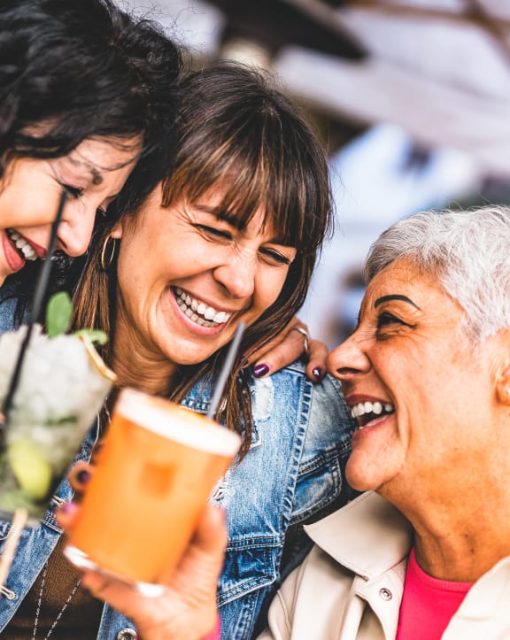 a group of people holding up drinks