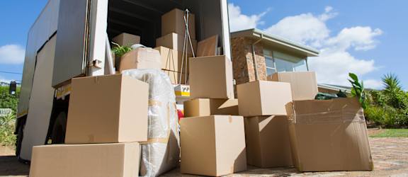 A moving truck is full of cardboard boxes.