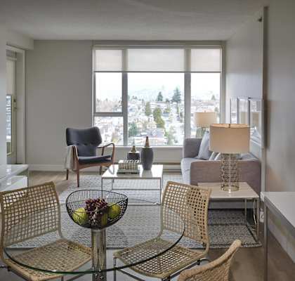 A living room with a glass table and chairs.