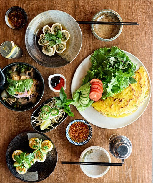a table with plates of food and bowls of food on it