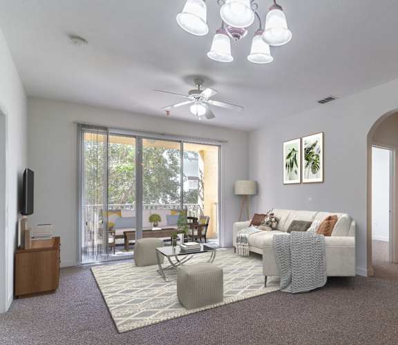 a living room with a ceiling fan and a sliding glass door to a patio