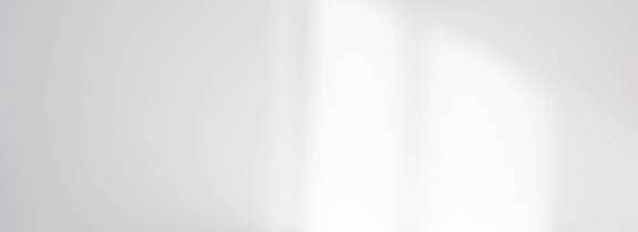 A white wall with a shadow of a window.