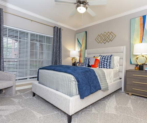 a bedroom with a bed and a ceiling fan