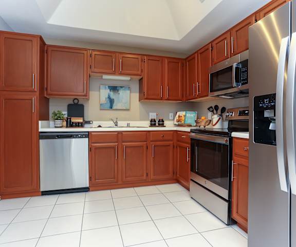 a kitchen with wooden cabinets and stainless steel appliances