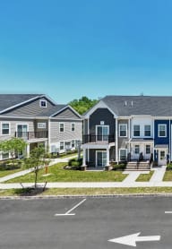a row of houses on a street with a parking lot