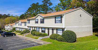 a row of houses with a parking lot