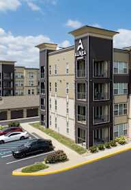 A parking lot in front of apartment buildings.