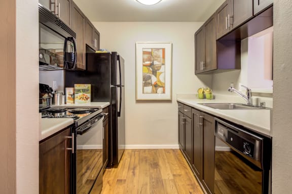 full kitchen with stainless steel appliances at the flats at obsidian