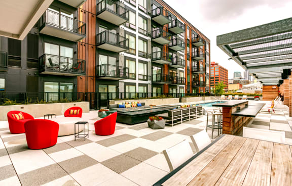 an outdoor patio with tables and chairs at a building with a pool