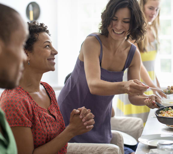 a group of people sitting around a table eating food