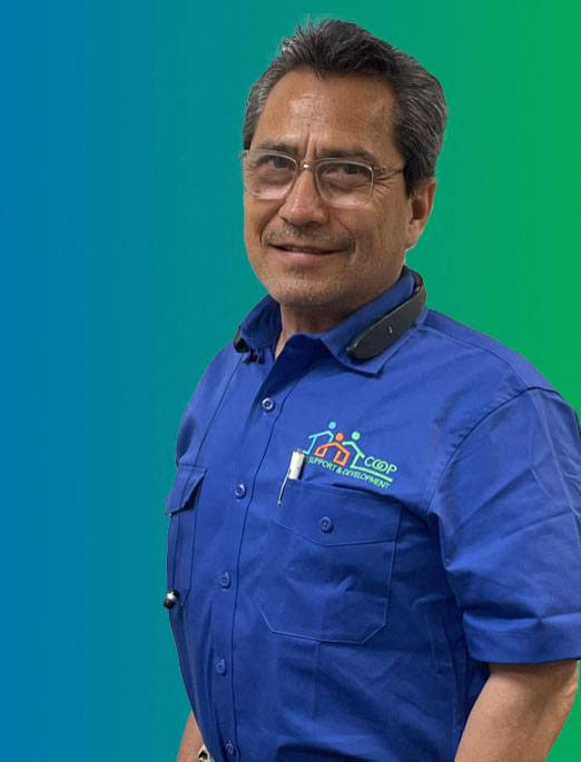 A man wearing a blue shirt with a logo on it.