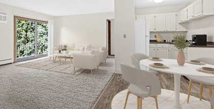 A modern living room with a dining table set for four.