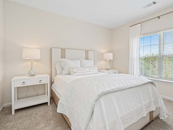 a living room with couches and mirrors on the wall at The Met Apartment Homes in MS 39402