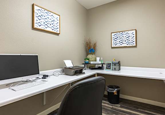 an office with a computer and a printer