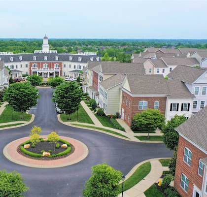 an aerial view of a neighborhood with houses and a street