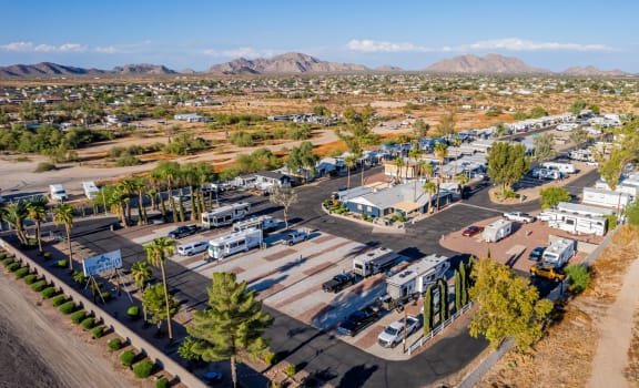 an aerial view of a rv park with mountains in the background