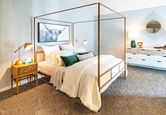 a bedroom with a bed and a glass canopy bed