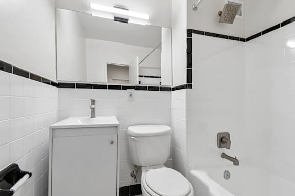 A white toilet sits next to a sink in a bathroom.